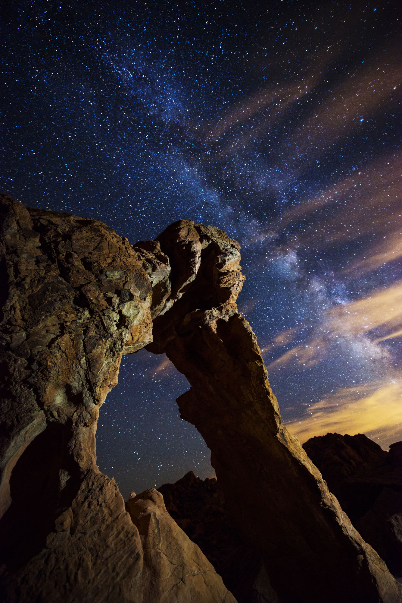 Elephant Rock illuminated at night under the Milky Way in Valley of Fire State Park, Nevada.