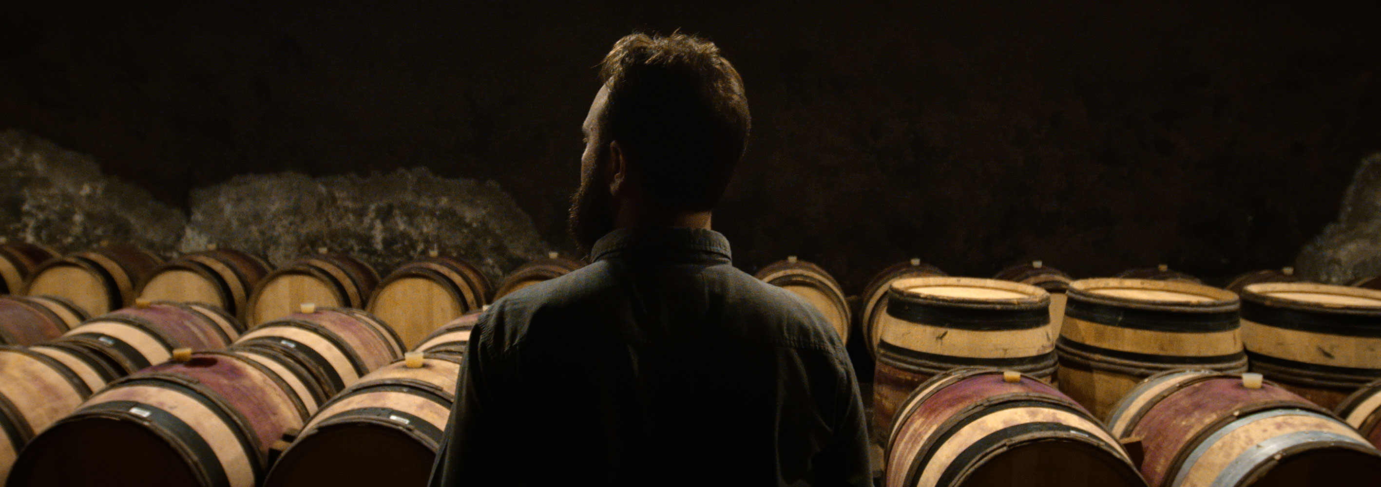 Winemaker Julien Howespian inspects barrels of wine in Burgundy, France