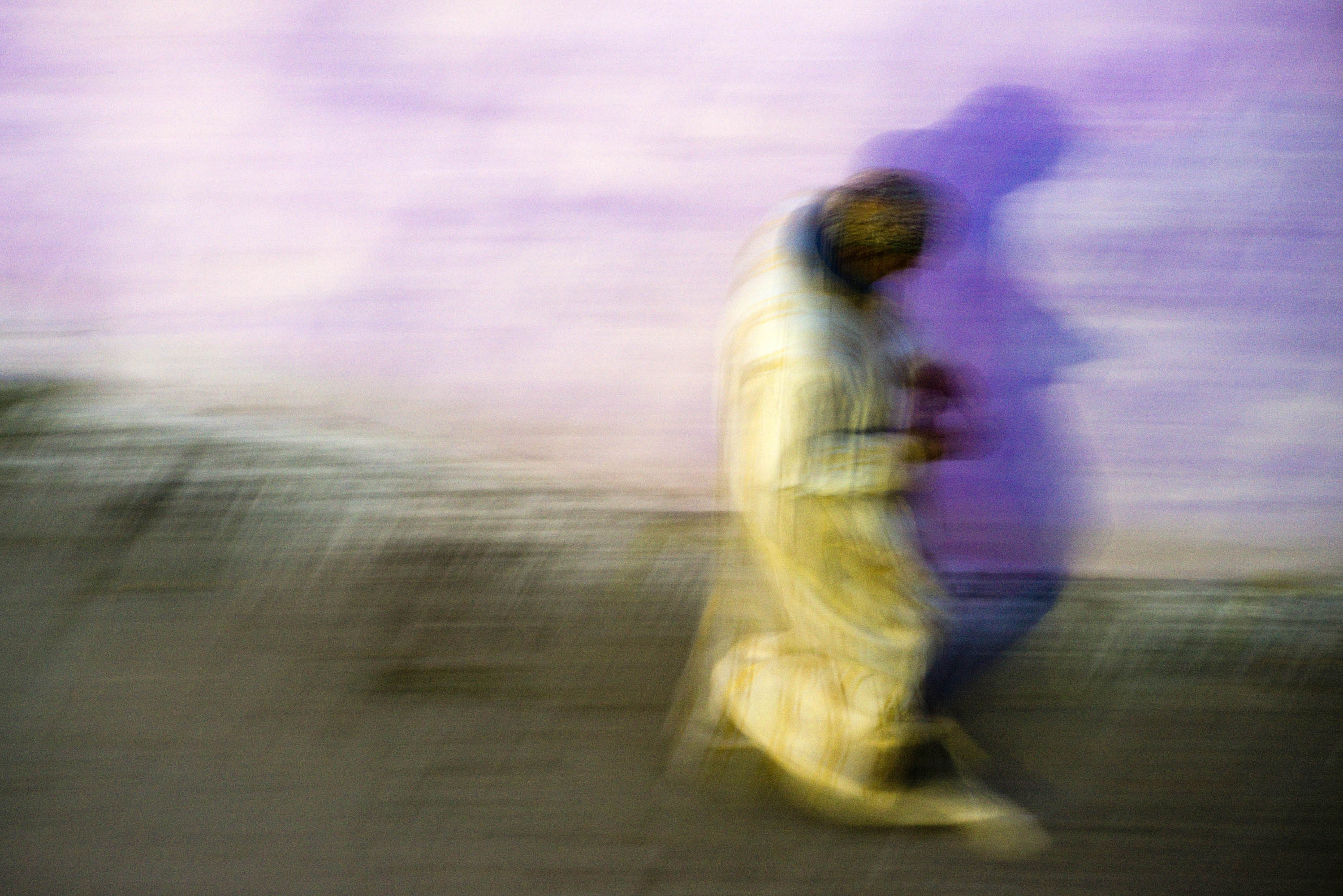 Man in djellaba walking in Tangier, Morocco.