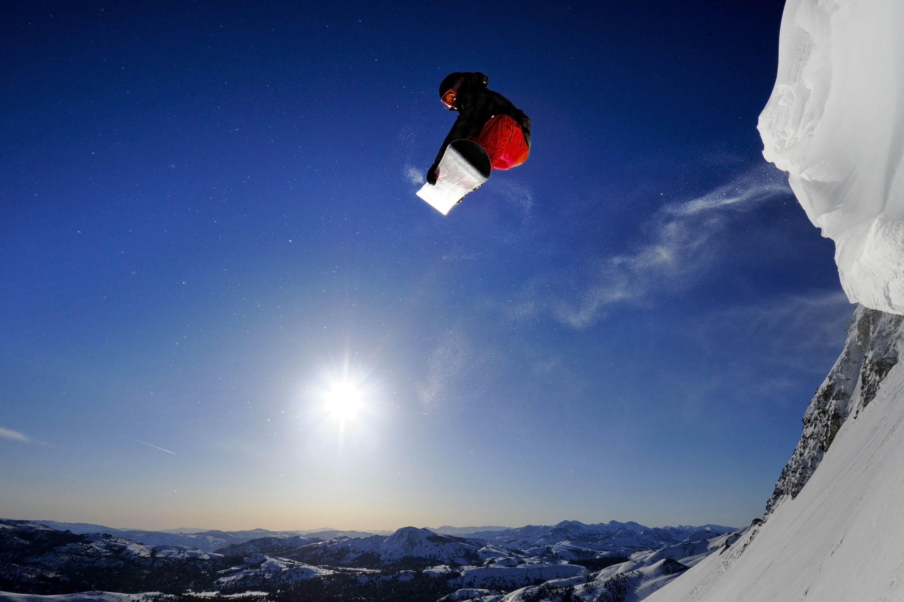 Snowboarder soaring in the air in the Sierra Nevada near Lake Tahoe, California.