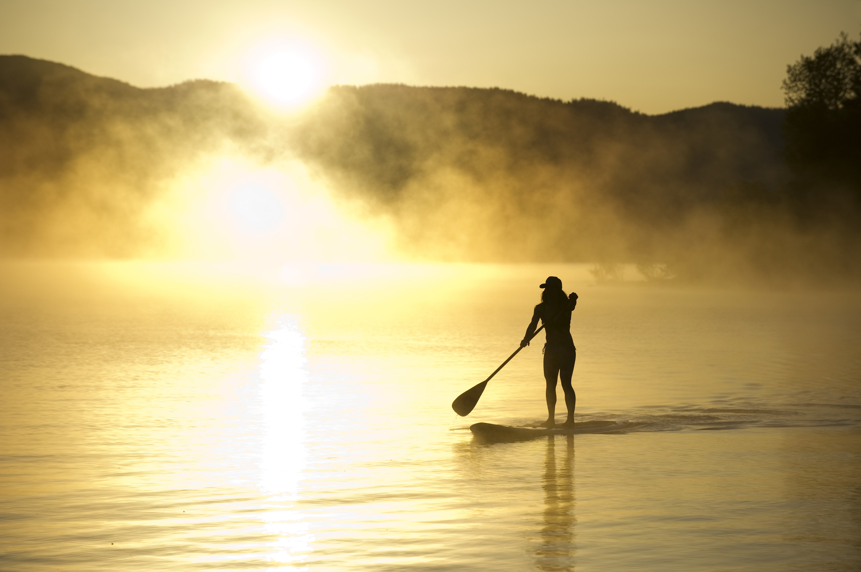 Stand up paddle boarding at sunrise in Lake Tahoe, CA.