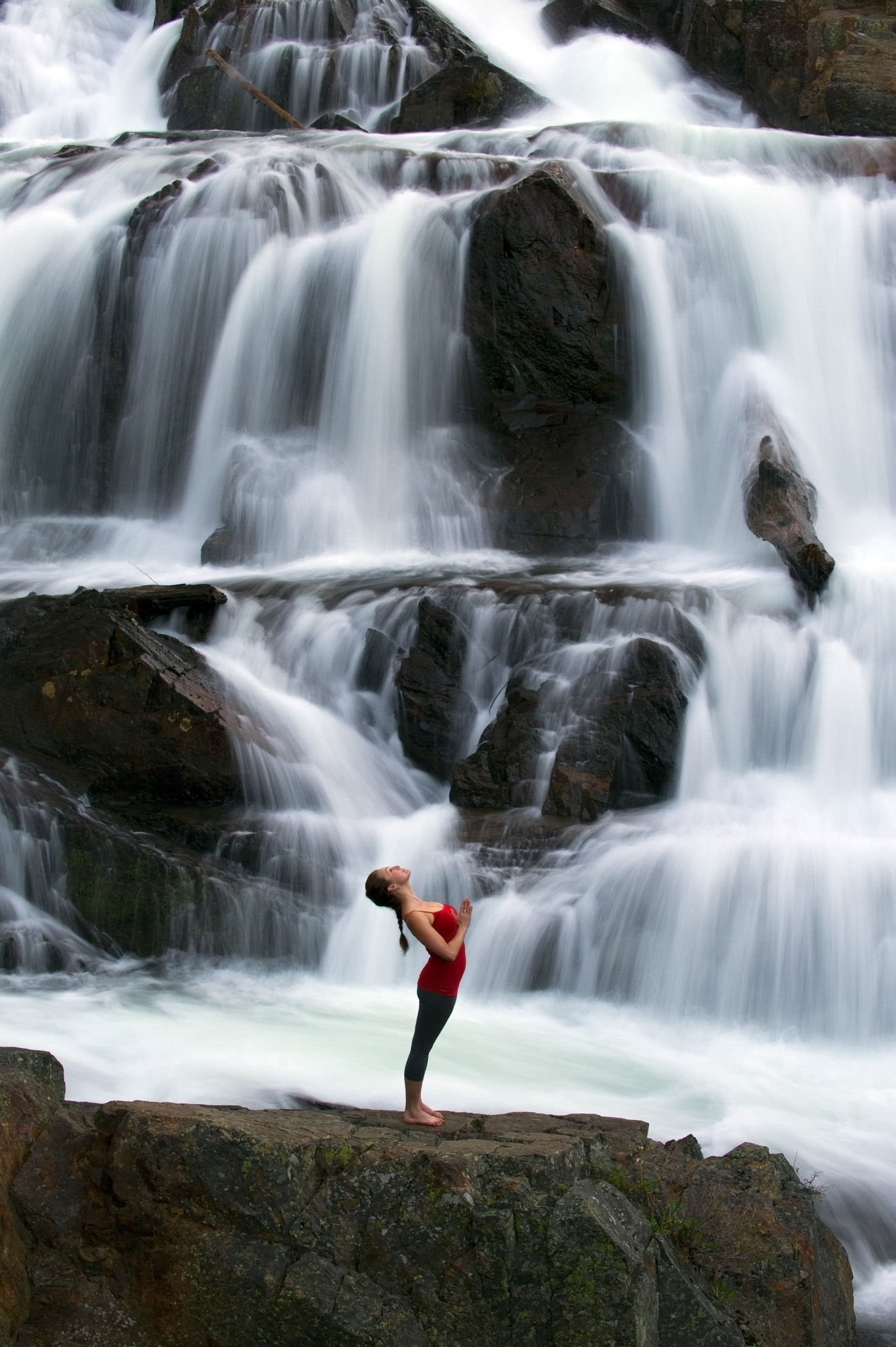 Yoga in front of a large waterfall in Lake Tahoe, California.